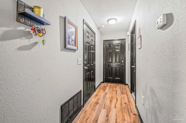 a view of a hallway view with wooden floor and staircase