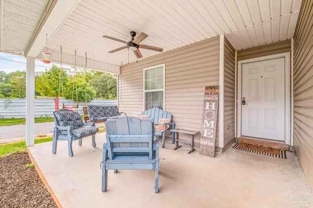 a view of a patio with couches chairs and backyard