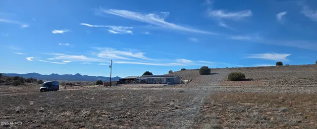 a view of ocean with a building in the background