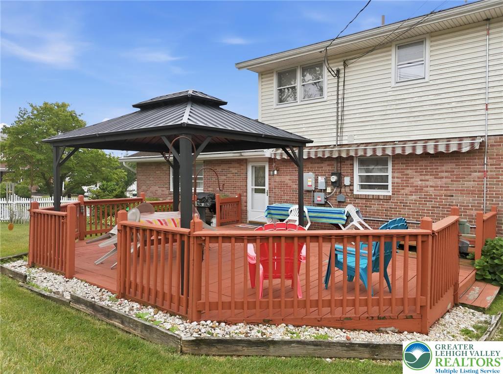 3303 Barklay Road Whitehall, PA 18052 - Photo 37 of 39 A spacious wooden deck with a built-in gazebo extends from the brick and siding exterior.