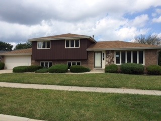 8714 Raintree Road Tinley Park, IL 60487 - Photo 1 of 13 a front view of a house with a yard