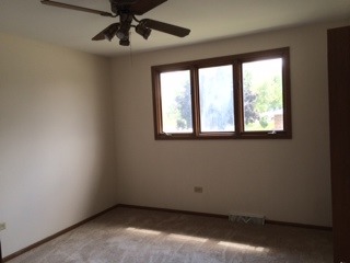 8714 Raintree Road Tinley Park, IL 60487 - Photo 3 of 13 a view of an empty room with a window