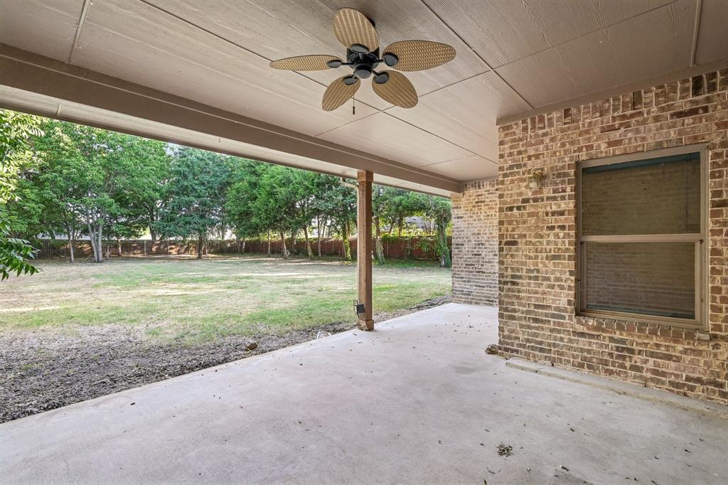 2617 Kirby Road Rowlett, TX 75088 - Photo 29 of 35 Covered patio with a ceiling fan, brick exterior, and concrete flooring
