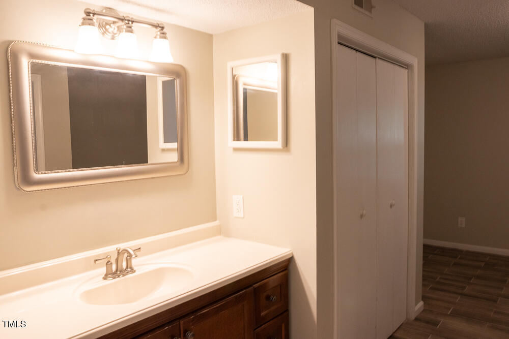 243 Schultz Street Chapel Hill, NC 27514 - Photo 13 of 21 a bathroom with a sink vanity and a mirror