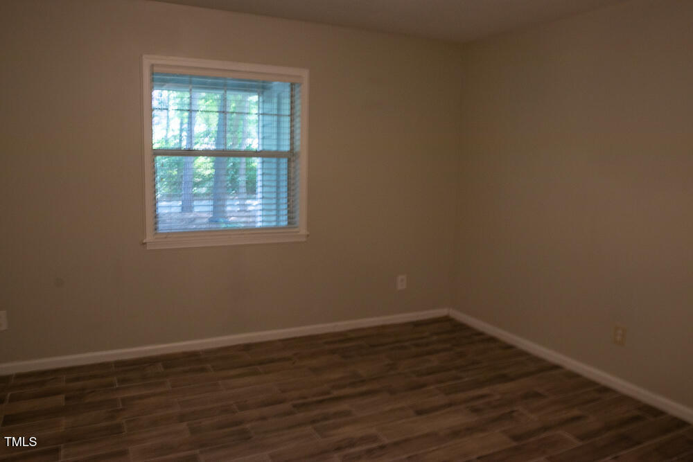 243 Schultz Street Chapel Hill, NC 27514 - Photo 14 of 21 an empty room with wooden floor and windows