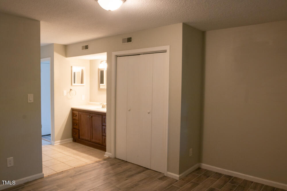 243 Schultz Street Chapel Hill, NC 27514 - Photo 16 of 21 a view of an empty room with wooden floor and a bathroom