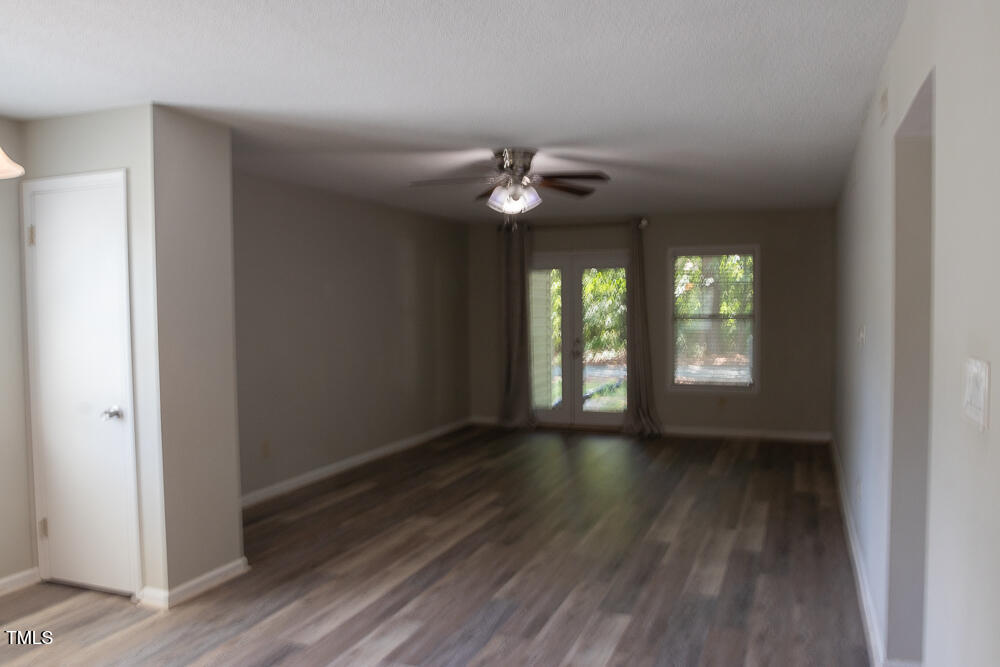 243 Schultz Street Chapel Hill, NC 27514 - Photo 3 of 21 a view of an empty room with wooden floor and a window