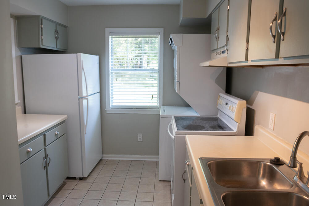 243 Schultz Street Chapel Hill, NC 27514 - Photo 7 of 21 a kitchen with a refrigerator sink and cabinets