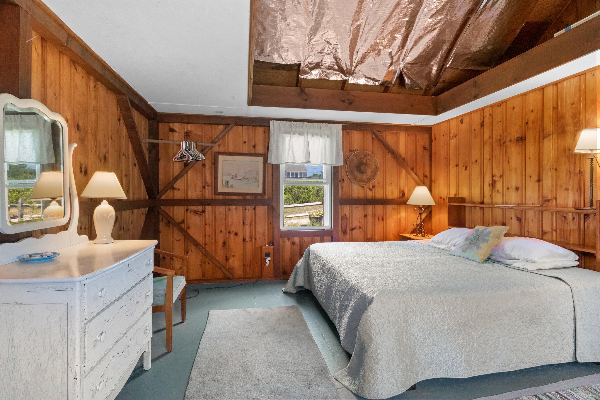 4 Bay View Path Truro, MA 02666 - Photo 35 of 71 a bedroom with a bed and a dresser next to a large window