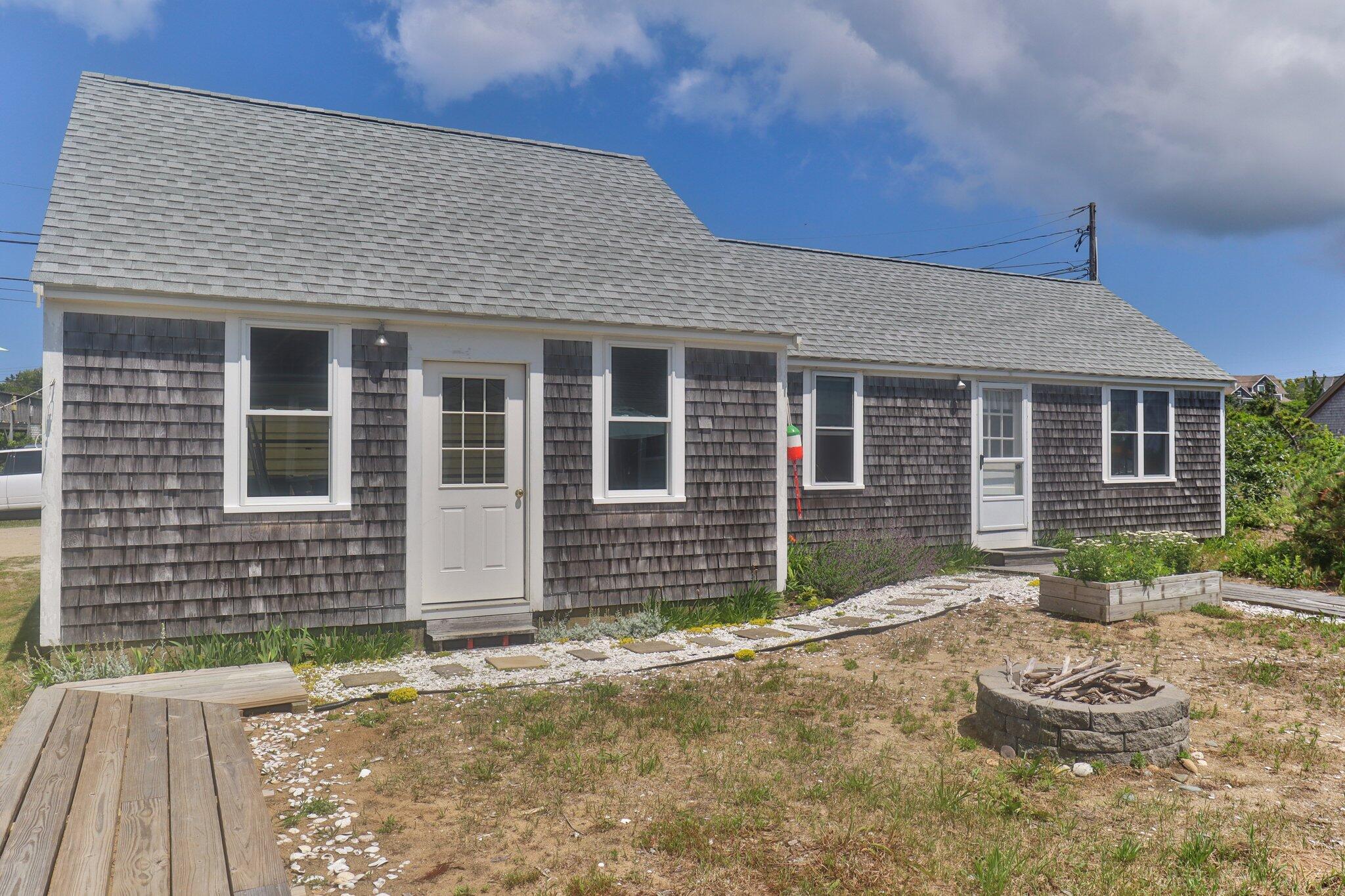 4 Bay View Path Truro, MA 02666 - Photo 36 of 71 a front view of a house with a garden