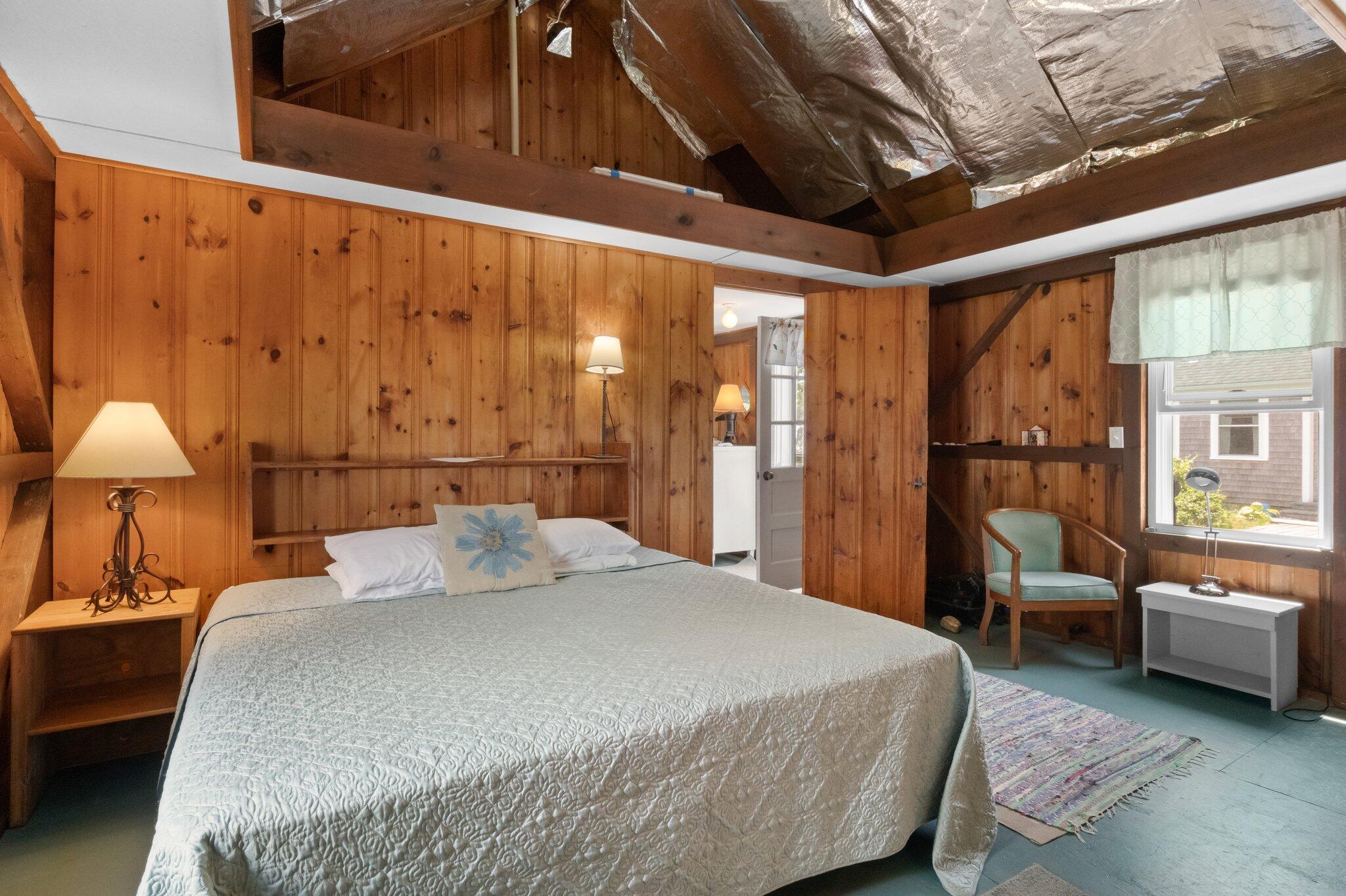 4 Bay View Path Truro, MA 02666 - Photo 37 of 71 a bedroom with a large bed and a chandelier