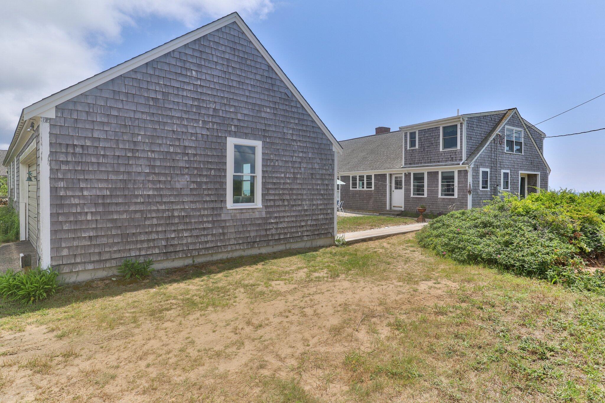 4 Bay View Path Truro, MA 02666 - Photo 44 of 71 a view of a house with a yard and plants