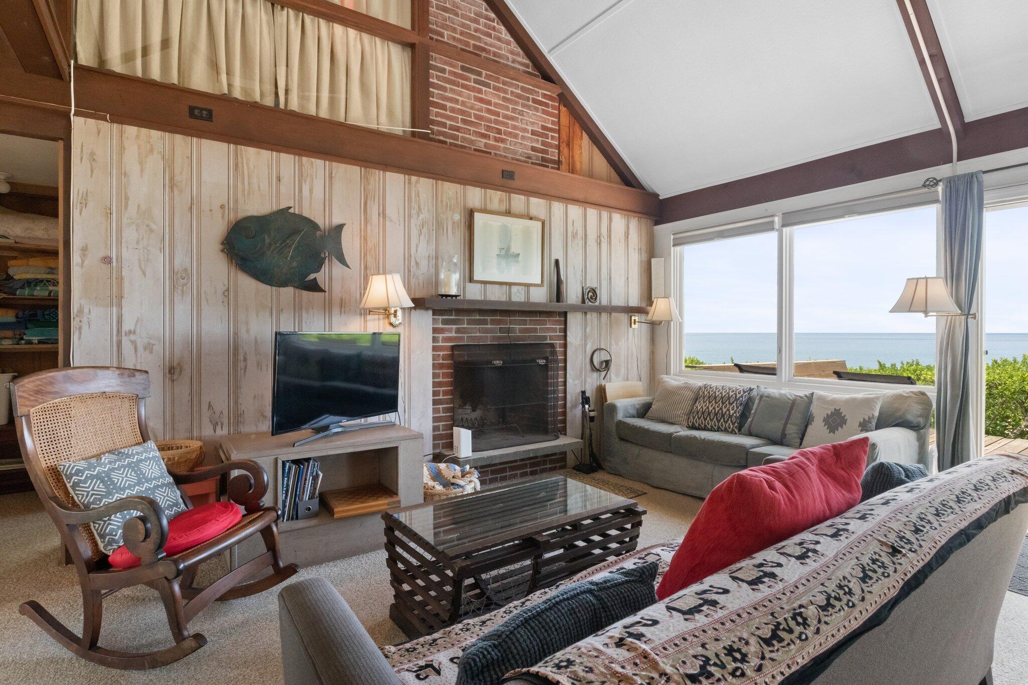 4 Bay View Path Truro, MA 02666 - Photo 8 of 71 a living room with furniture kitchen view and a fireplace