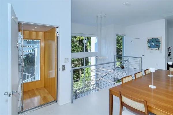 a view of a patio with table and chairs with wooden floor and fence