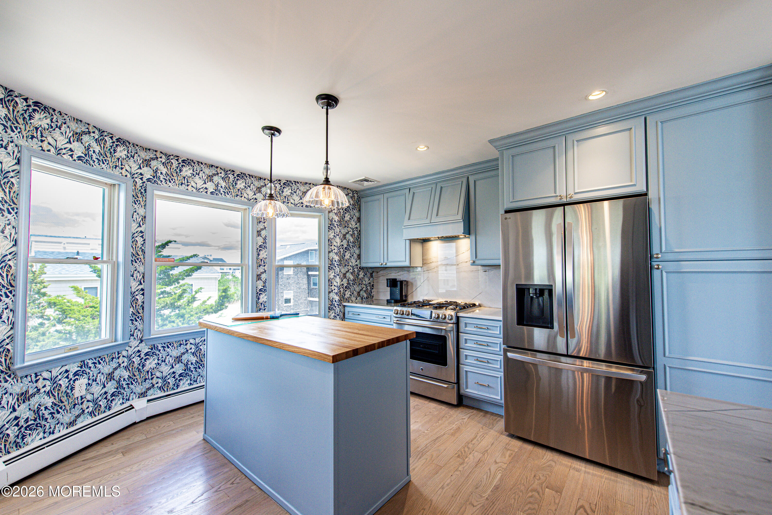 5 A Sunset Boulevard Barnegat Light, NJ 08006 - Photo 14 of 65 a kitchen with stainless steel appliances granite countertop a refrigerator a sink dishwasher a oven and a dining table with wooden floor