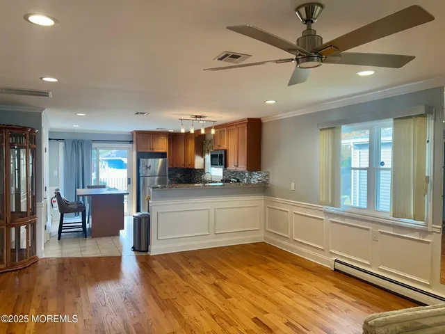 a kitchen with stainless steel appliances granite countertop a refrigerator and a stove top oven