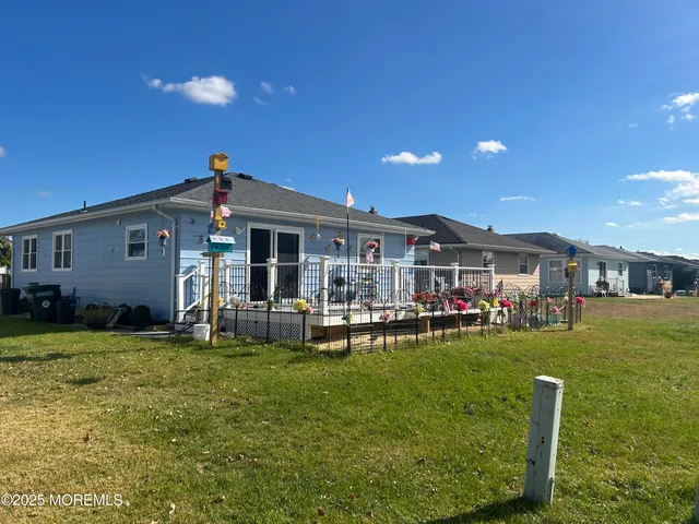 a front view of a house with a garden and patio