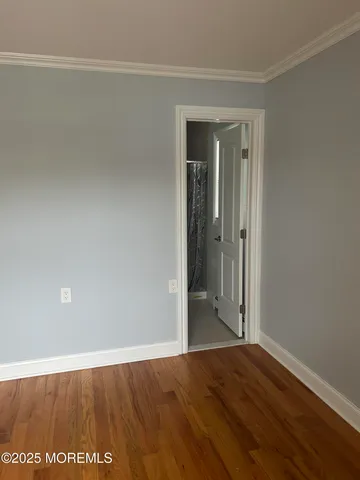 a view of hallway with wooden floor