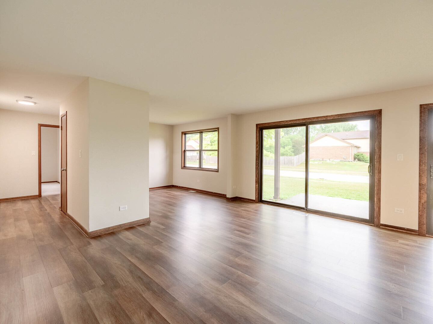 19211 Elm Drive, Unit 145 Country Club Hills, IL 60478 - Photo 5 of 16 a view of an empty room with wooden floor and a window