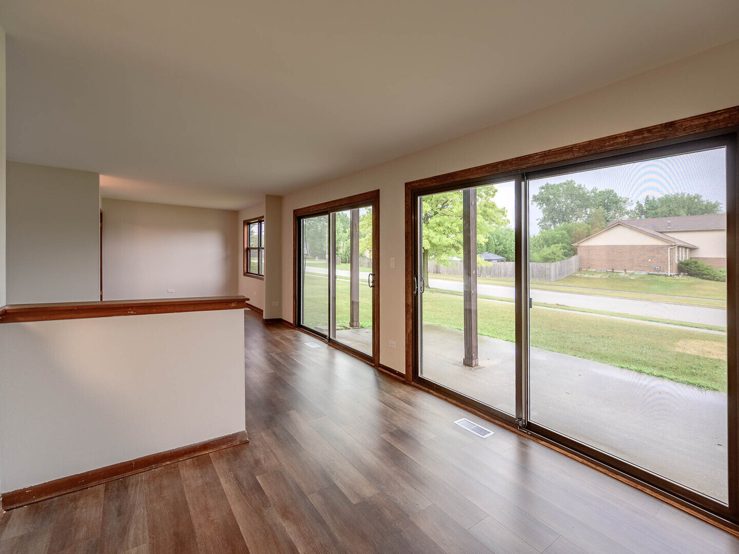 19211 Elm Drive, Unit 145 Country Club Hills, IL 60478 - Photo 7 of 16 a view of an empty room with wooden floor and a window