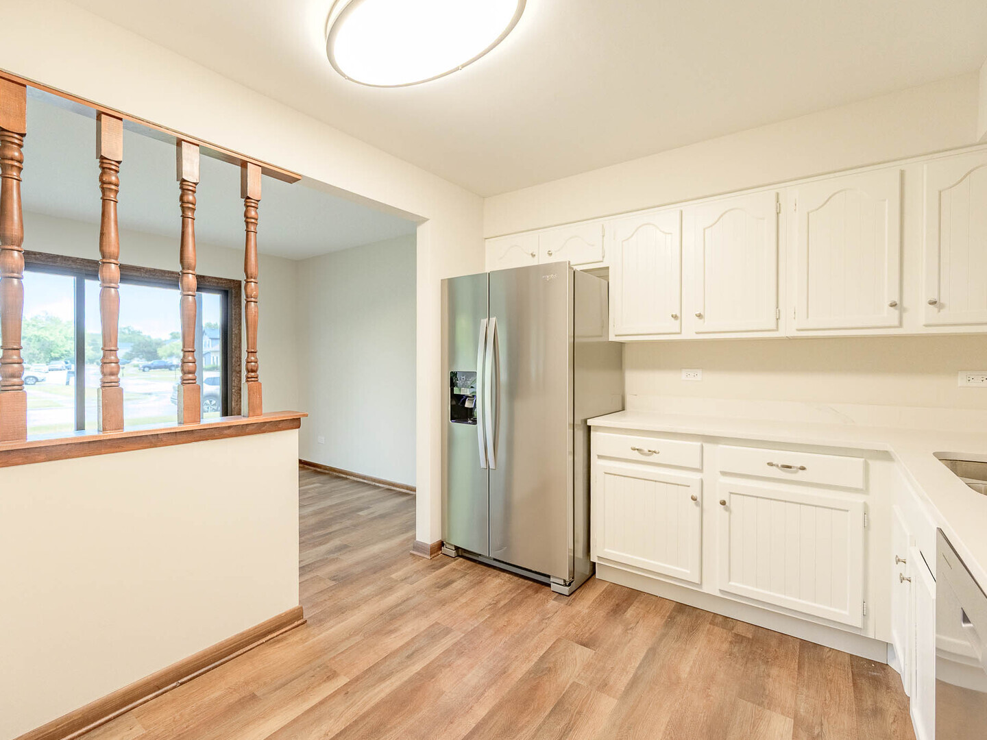 19211 Elm Drive, Unit 145 Country Club Hills, IL 60478 - Photo 9 of 16 a kitchen with granite countertop white cabinets and refrigerator