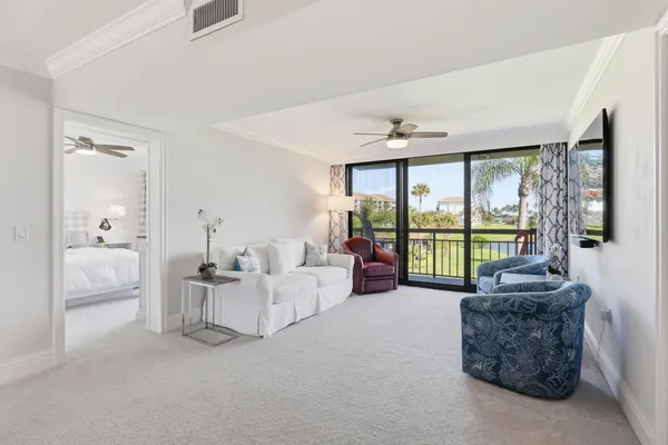 a living room with furniture and large windows