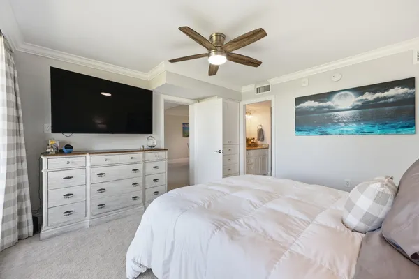 a bedroom with a large bed and a flat screen tv