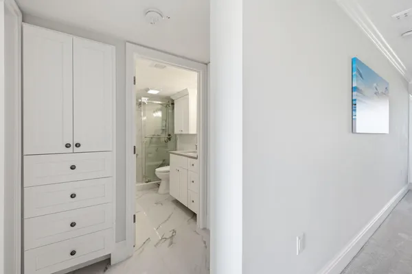 a bathroom with a granite countertop sink a toilet and shower