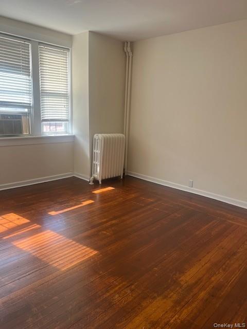 169 Tibbetts Road, Unit 1 Yonkers, NY 10705 - Photo 12 of 17 an empty room with wooden floor and windows