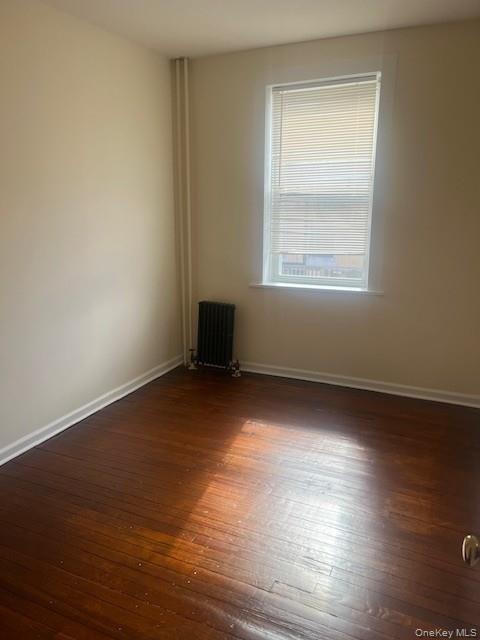 169 Tibbetts Road, Unit 1 Yonkers, NY 10705 - Photo 13 of 17 an empty room with wooden floor and windows