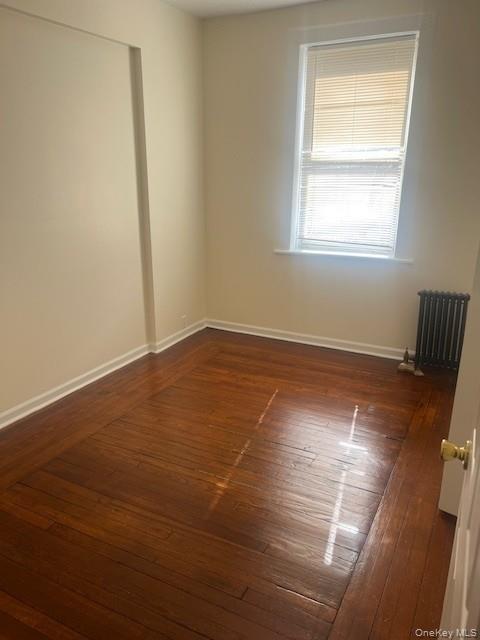 169 Tibbetts Road, Unit 1 Yonkers, NY 10705 - Photo 14 of 17 an empty room with wooden floor and windows
