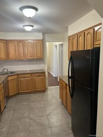 a kitchen with a refrigerator and a sink