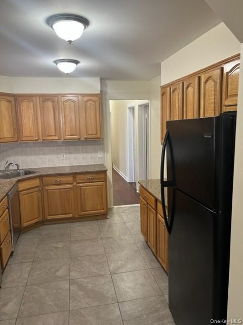 169 Tibbetts Road, Unit 1 Yonkers, NY 10705 - Photo 3 of 17 a kitchen with a refrigerator and a sink