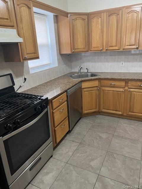 169 Tibbetts Road, Unit 1 Yonkers, NY 10705 - Photo 4 of 17 a kitchen with stainless steel appliances granite countertop a stove a sink and a white cabinets
