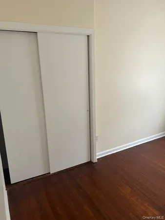 an empty room with wooden floor