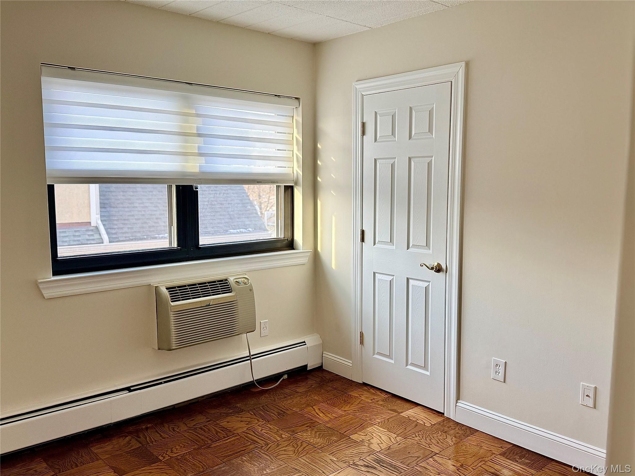 505 White Plains Road, Unit 2G Eastchester, NY 10709 - Photo 10 of 11 a view of an empty room with wooden floor and a window