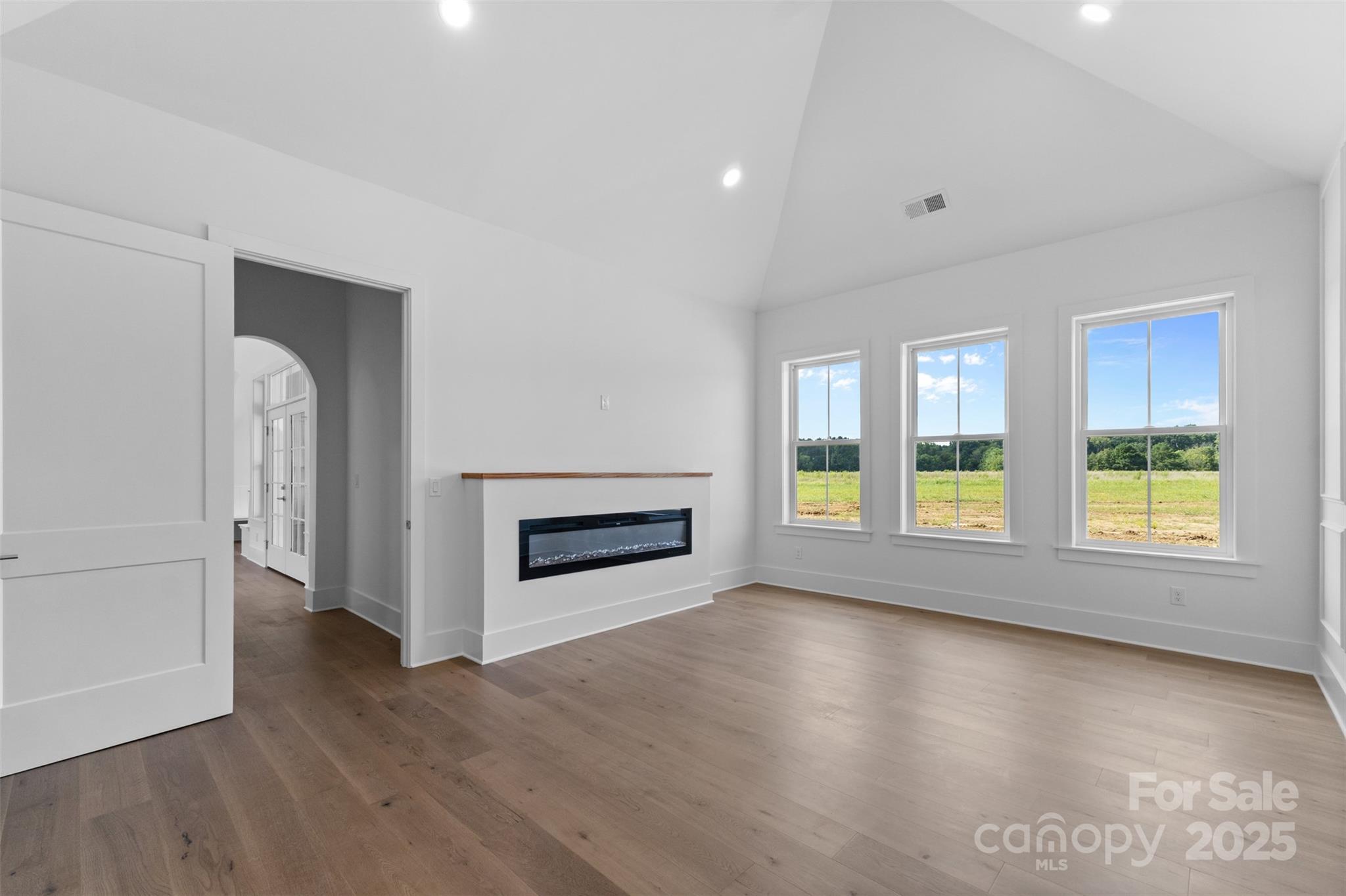 2296 Bridgewater Road, Unit 2 Rock Hill, SC 29730 - Photo 12 of 31 an empty room with wooden floor fireplace and windows
