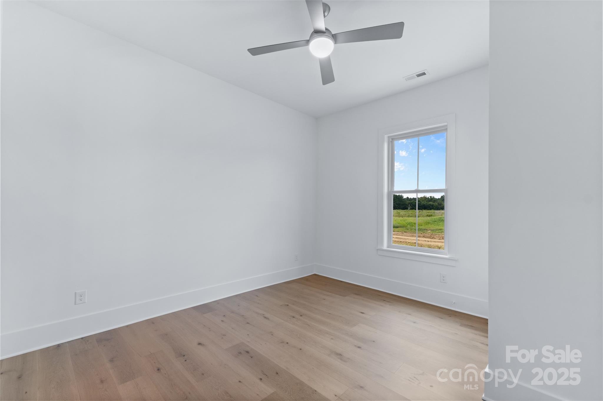 2296 Bridgewater Road, Unit 2 Rock Hill, SC 29730 - Photo 19 of 31 an empty room with a window and a ceiling fan