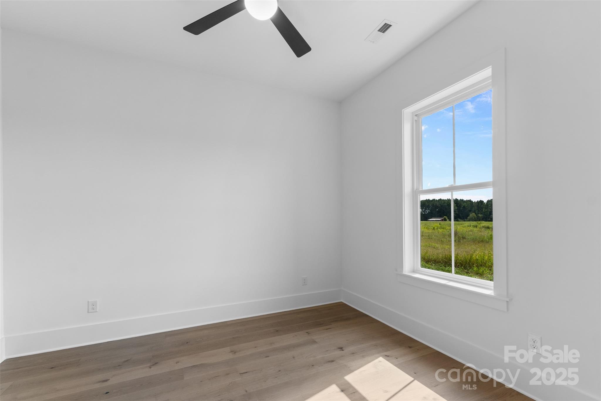 2296 Bridgewater Road, Unit 2 Rock Hill, SC 29730 - Photo 23 of 31 a view of an empty room with a window and wooden floor
