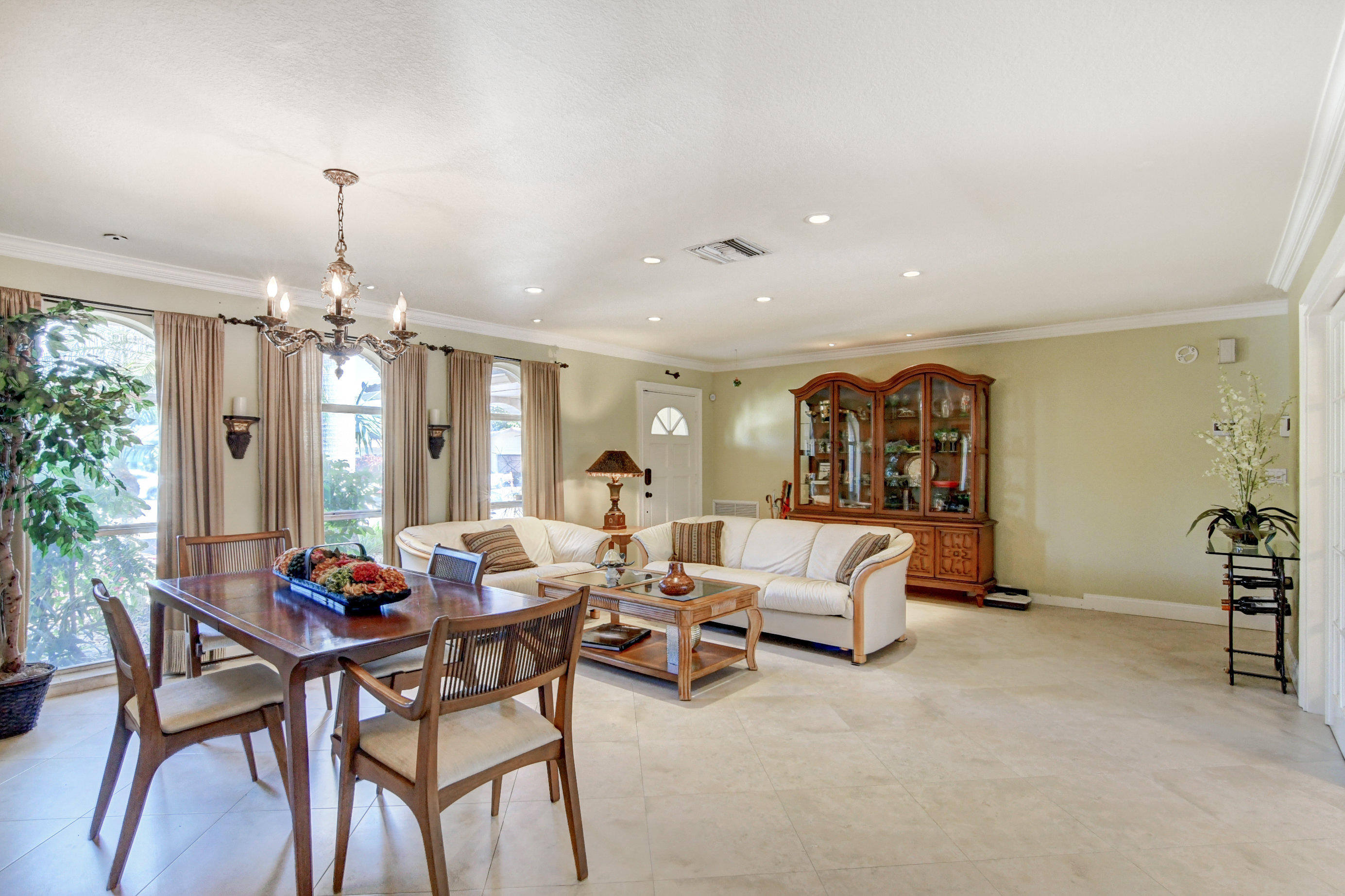 1720 Southwest 9th Street Boca Raton, FL 33486 - Photo 12 of 75 a living room with furniture and a chandelier