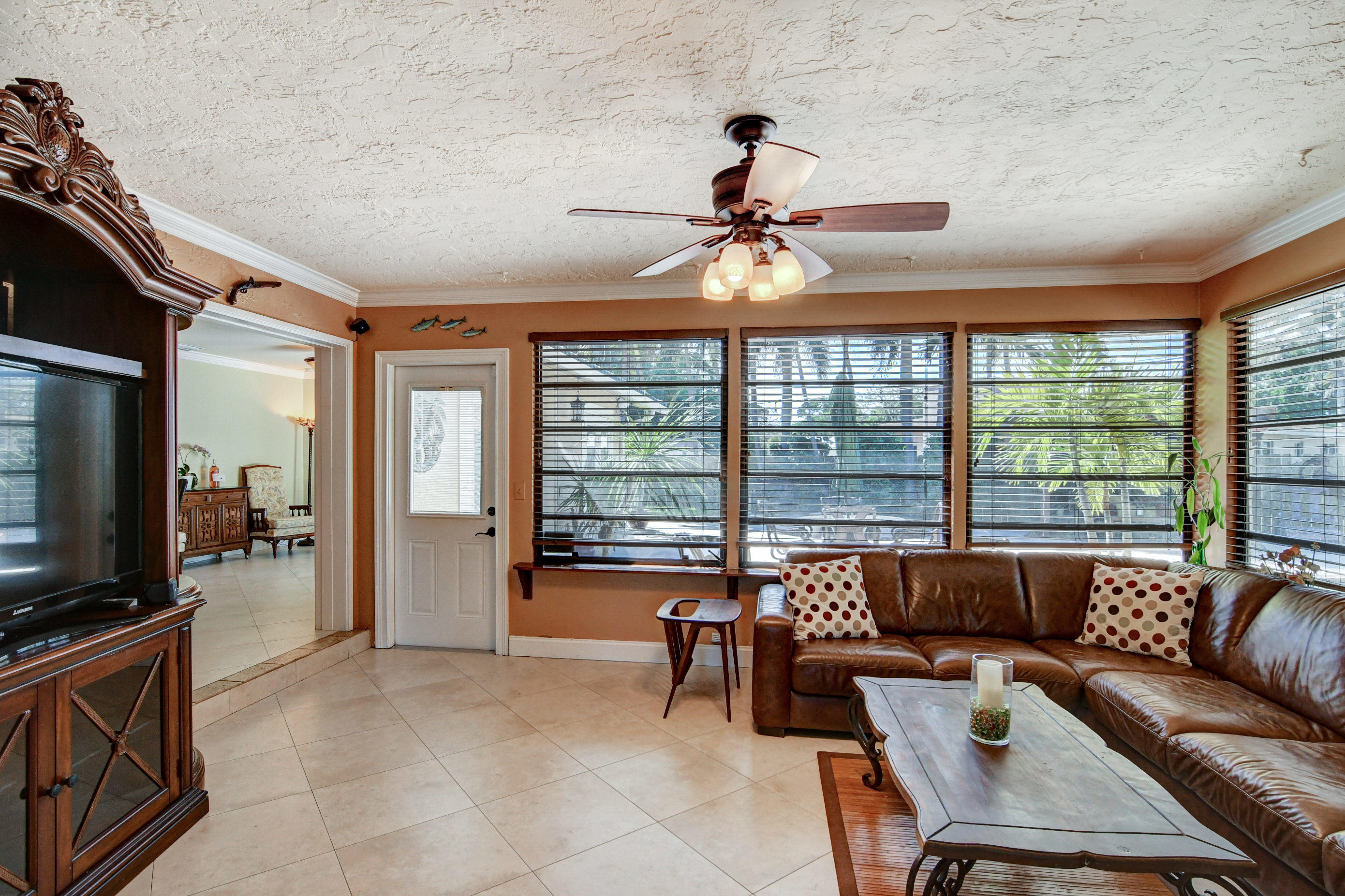 1720 Southwest 9th Street Boca Raton, FL 33486 - Photo 16 of 75 a living room with furniture a flat screen tv and a large window