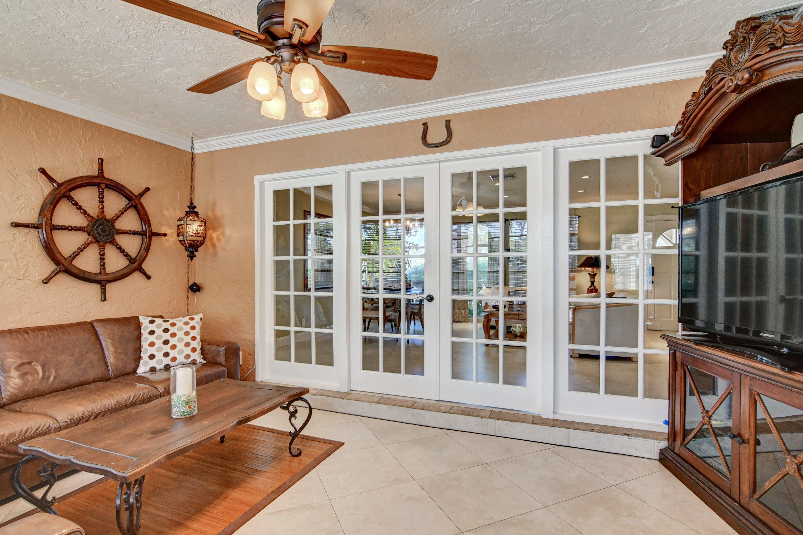 1720 Southwest 9th Street Boca Raton, FL 33486 - Photo 18 of 75 a living room with furniture a window and a chandelier