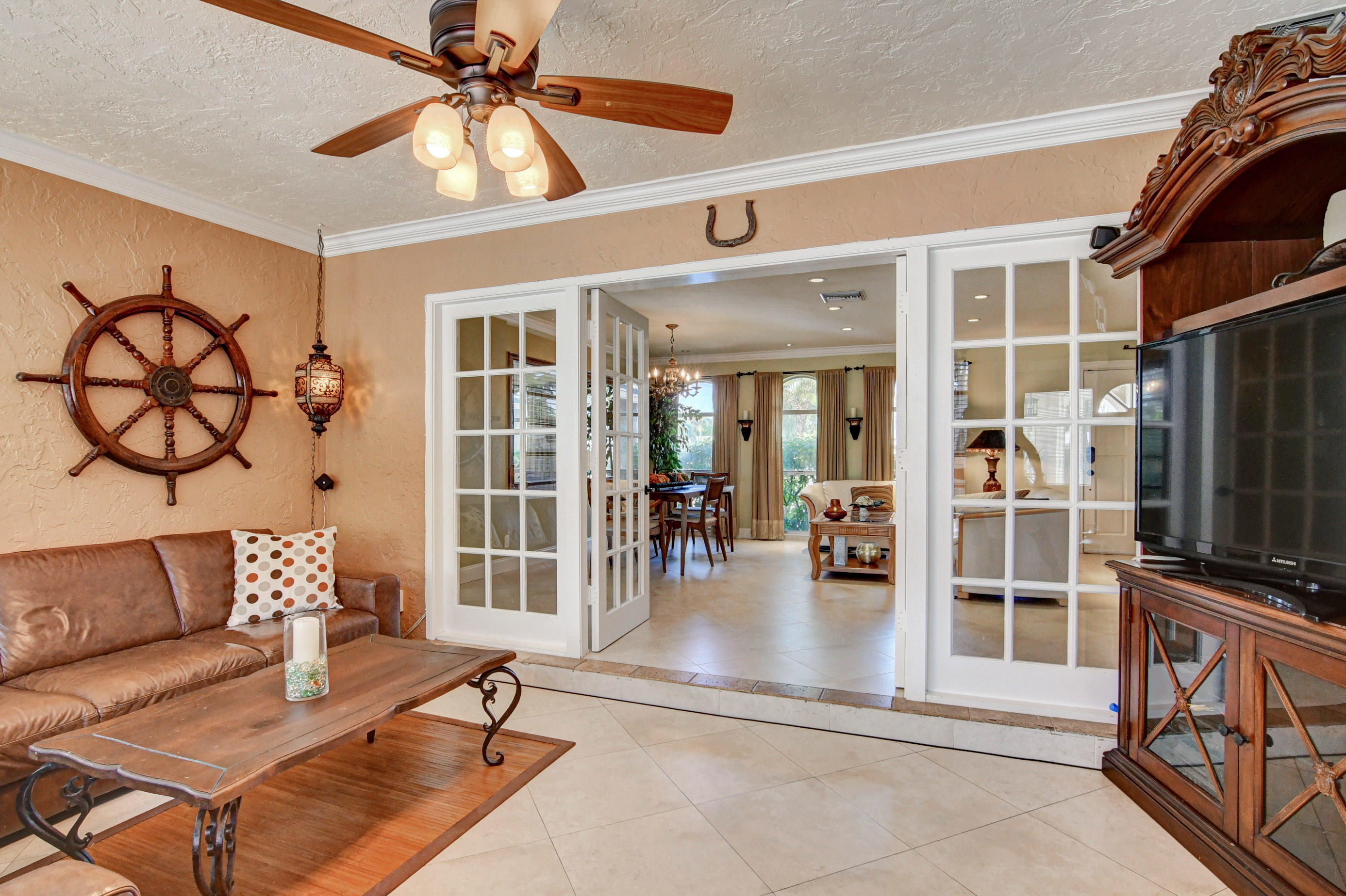 1720 Southwest 9th Street Boca Raton, FL 33486 - Photo 19 of 75 a living room with furniture a flat screen tv and a floor to ceiling window