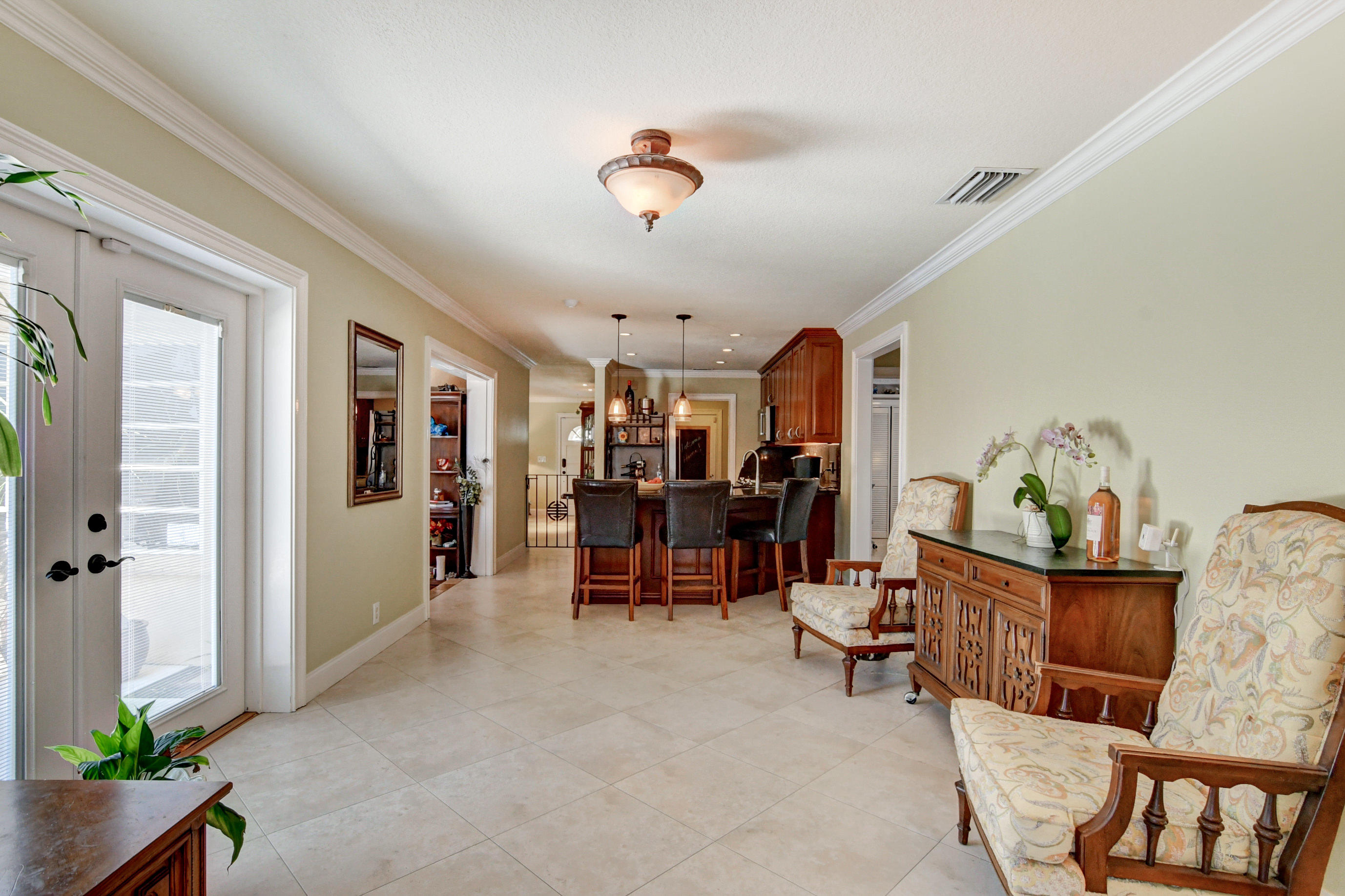 1720 Southwest 9th Street Boca Raton, FL 33486 - Photo 22 of 75 a view of living room filled with furniture and a chandelier