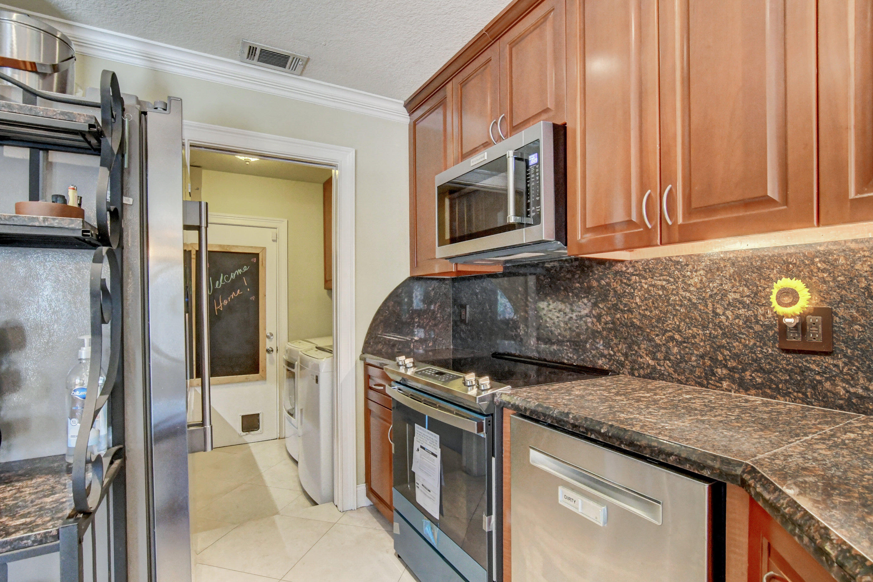 1720 Southwest 9th Street Boca Raton, FL 33486 - Photo 25 of 75 a kitchen with stainless steel appliances granite countertop a stove and a microwave