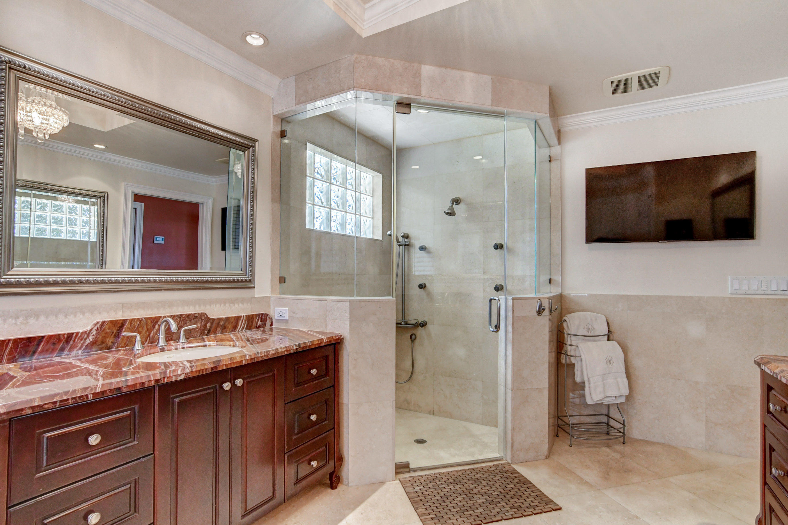 1720 Southwest 9th Street Boca Raton, FL 33486 - Photo 40 of 75 a spacious bathroom with a granite countertop sink mirror and shower