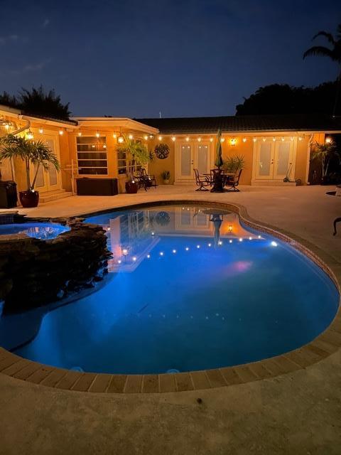 1720 Southwest 9th Street Boca Raton, FL 33486 - Photo 4 of 75 a view of a swimming pool with an outdoor seating