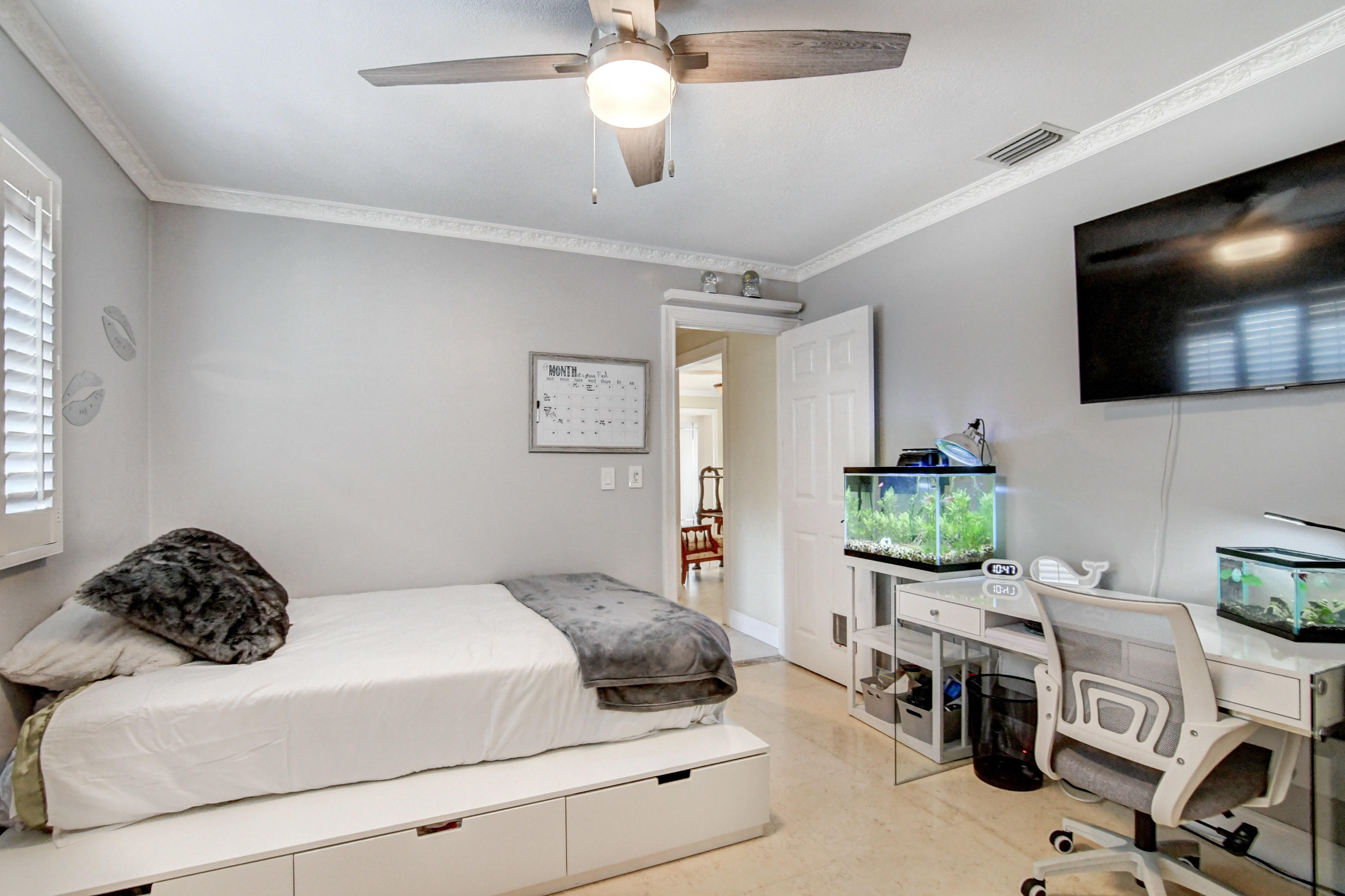 1720 Southwest 9th Street Boca Raton, FL 33486 - Photo 47 of 75 a bedroom with a bed a flat screen tv and a couch