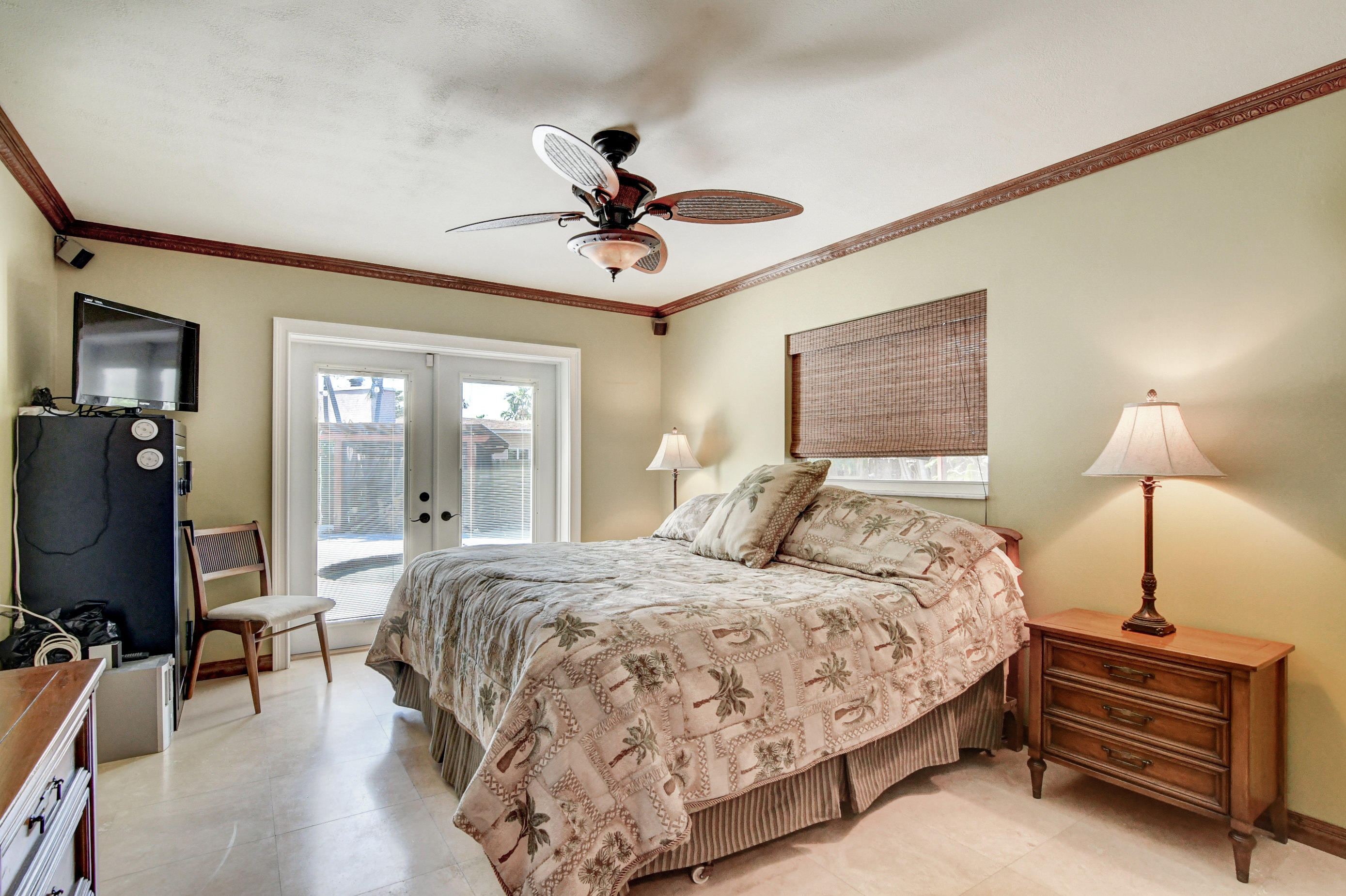 1720 Southwest 9th Street Boca Raton, FL 33486 - Photo 48 of 75 a bedroom with a bed and a chandelier