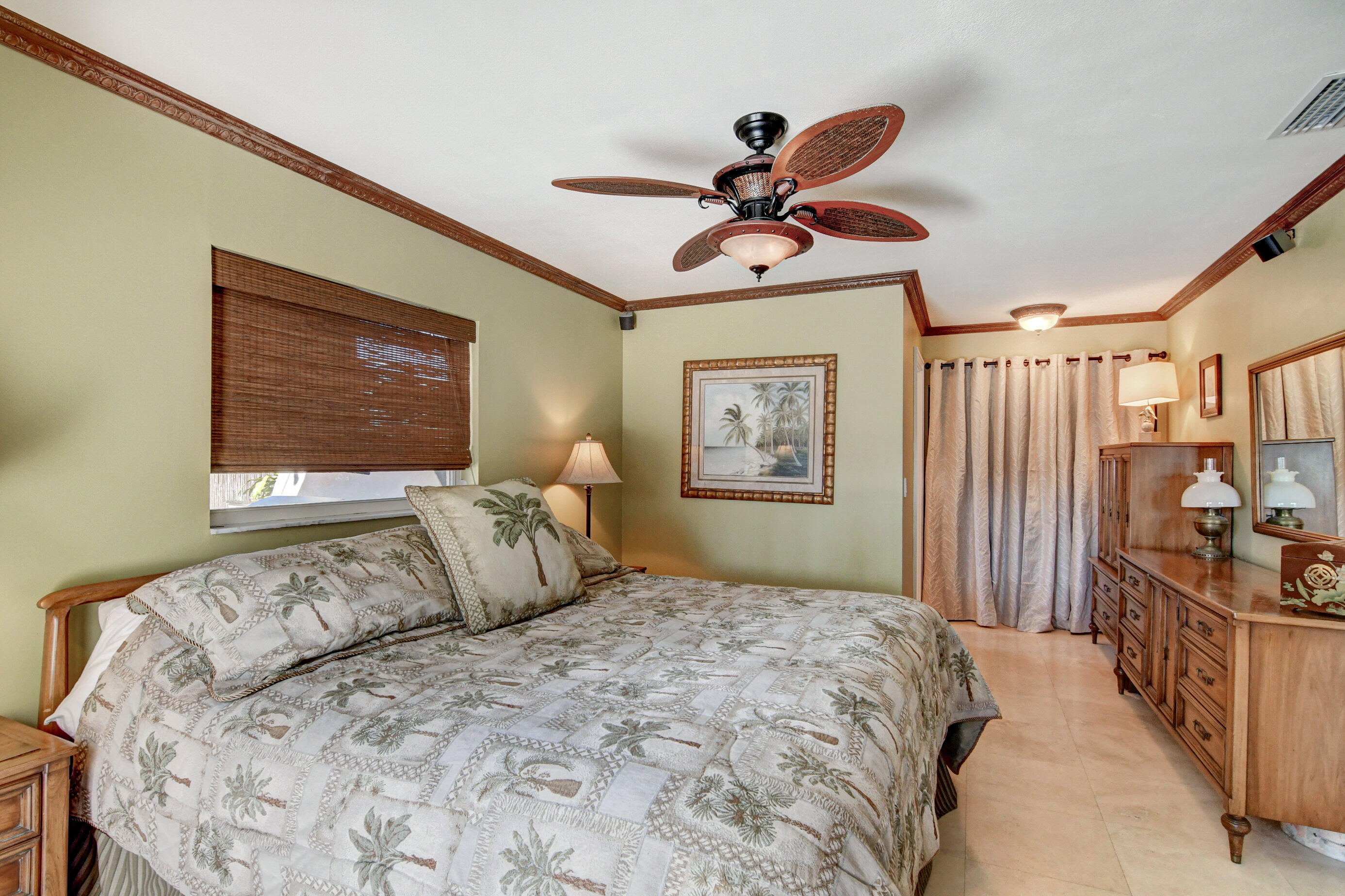 1720 Southwest 9th Street Boca Raton, FL 33486 - Photo 50 of 75 a bedroom with a large bed and a chandelier